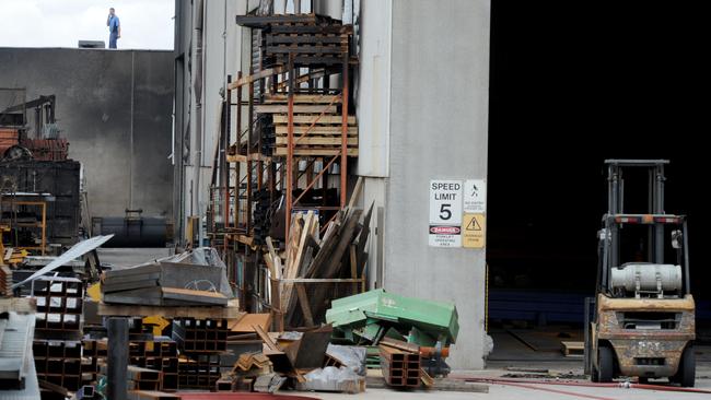 Fire crews mop up at the scene after yesterday's factory fire at Thornycroft Street Campbellfield. Picture: Andrew Henshaw