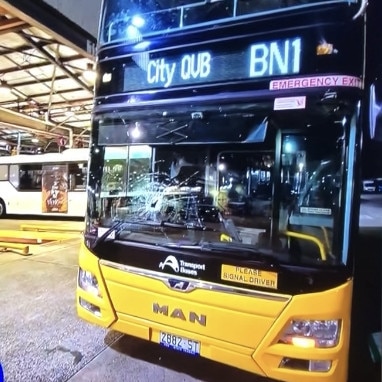 The driver was injured by flying glass after this B-Line double-decker bus was hit by a projectile thrown from a bridge. Picture: 9News