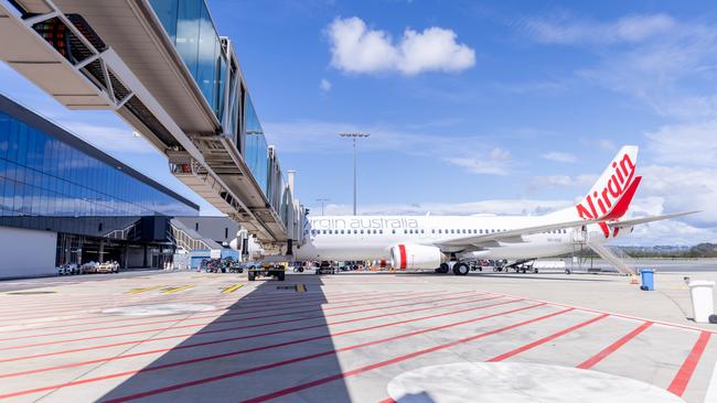 A Virgin flight using an aerobridge at Gold Coast Airport's new terminal expansion. Picture: Luke Marsden.