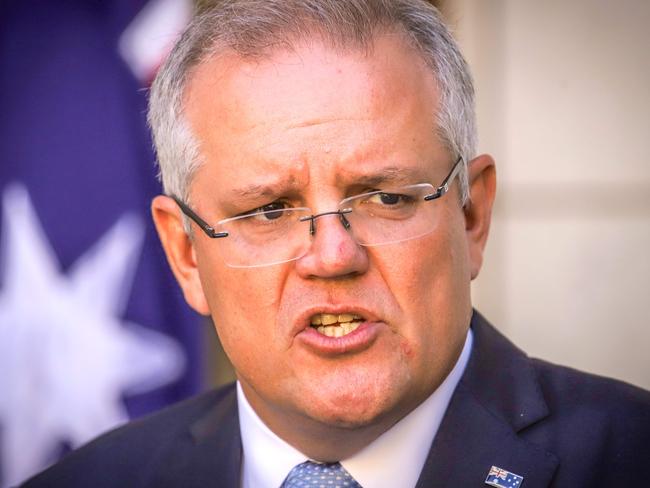 Australian Prime Minister Scott Morrison speaks during a press conference at Australia's Parliament House in Canberra on March 22, 2020. - Morrison told citizens to cancel any domestic travel plans to slow the spread of coronavirus, warning stronger measures were imminent to deal with localised outbreaks. (Photo by DAVID GRAY / AFP)