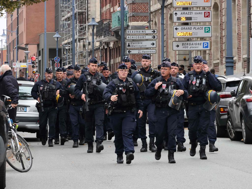 CRS riot police arrive to cordon off an area near the Gambetta high school in Arras, northeastern France. Picture: AFP