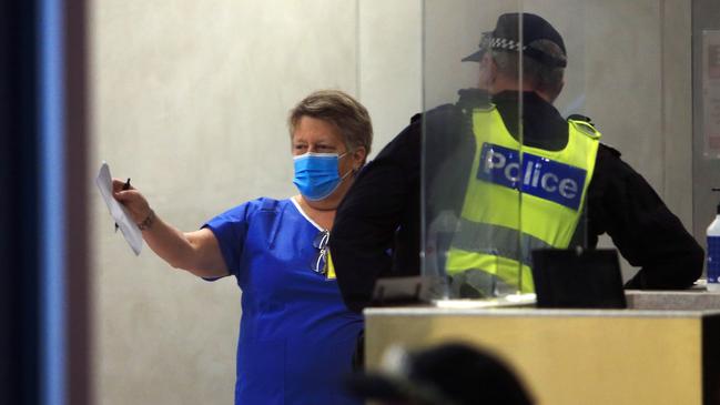 Police and medical staff in the Novotel in Melbourne’s Southbank. Picture: Aaron Francis