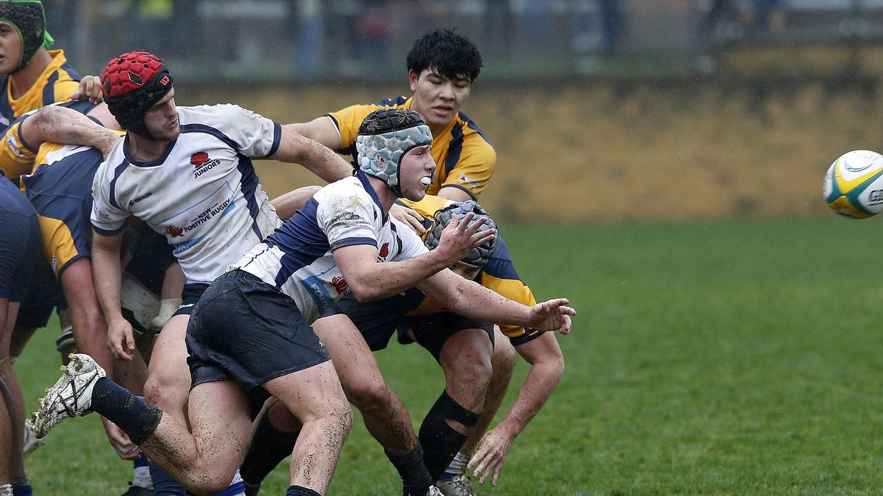 NSW's Joe Hutton gets the ball away in the match against ACT in 2022.