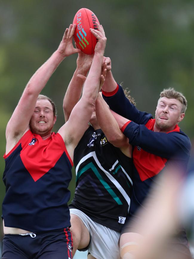 Swifts Creek’s Alastair Commins and Zac Tactor sandwich Omeo-Benambra’s Jai Hayward.