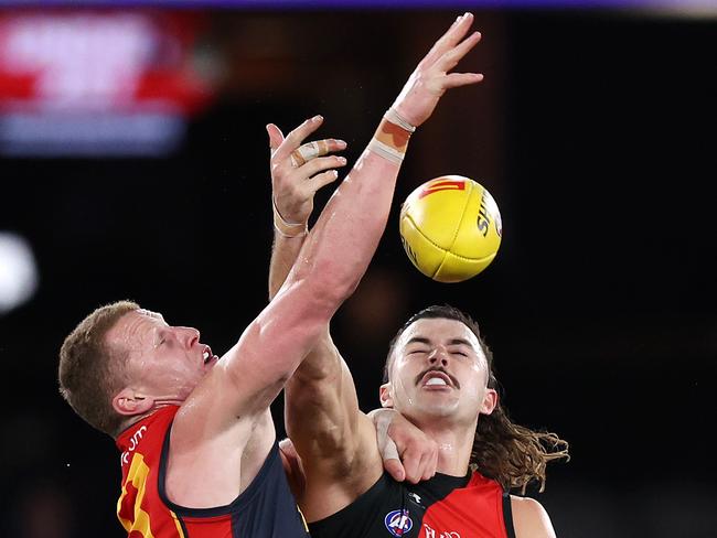 MELBOURNE, JULY 19, 2024: 2024 AFL - Round 19 - Essendon Bombers v Adelaide Crows at Marvel Stadium. Reilly O'Brien of the Crows and Sam Draper of the Bombers in action. Picture: Mark Stewart