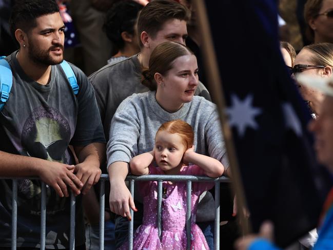 A girl covers her ears during the Anzac Day parade march in Sydney. Picture: Jenny Evans/Getty Images