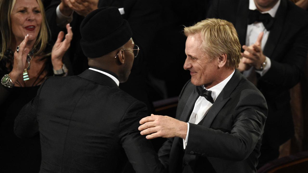 Mahershala Ali, left, and Viggo Mortensen congratulate each other as they accept the award for best picture for Green Book. Picture: AP