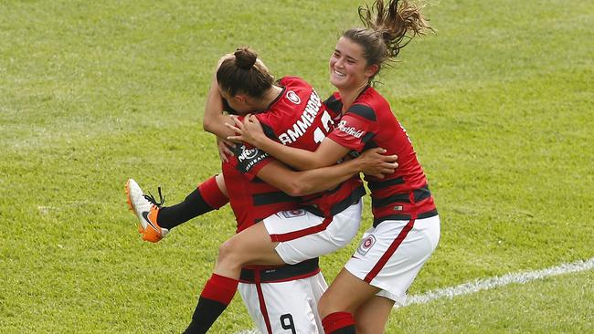 Wanderers Katherine Stengel (9) celebrates with Eliza Ammendolia and Rachel Lowe after scoring during the round three W-League match against Adelaide United.