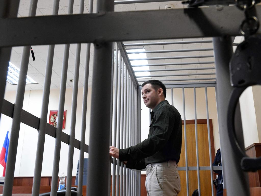 US ex-marine Trevor Reed was charged with attacking police, stands inside a defendants' cage during a court hearing in Moscow. Picture: Alexander Nemenov / AFP)