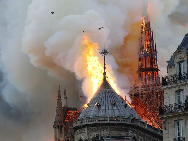Smoke and flames rise during a fire at the landmark Notre-Dame Cathedral in central Paris on April 15, 2019, potentially involving renovation works being carried out at the site, the fire service said. (Photo by FRANCOIS GUILLOT / AFP)