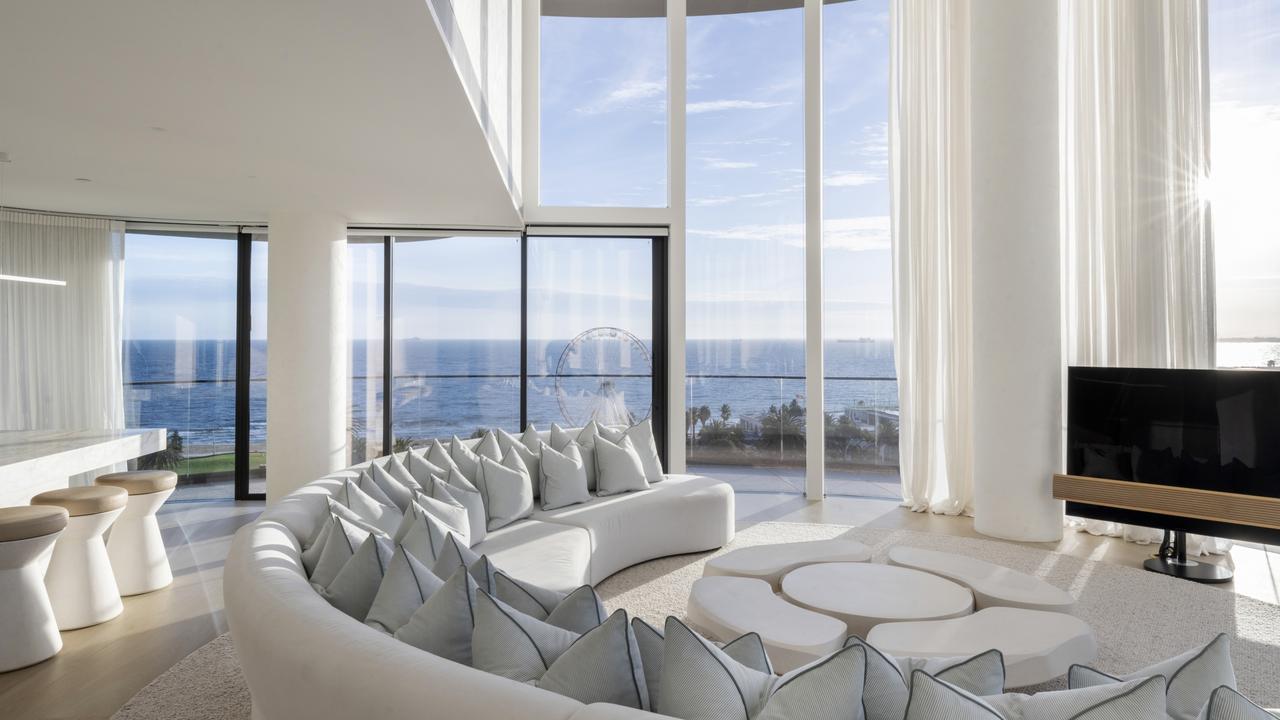 The huge living room with floor-to-ceiling windows.
