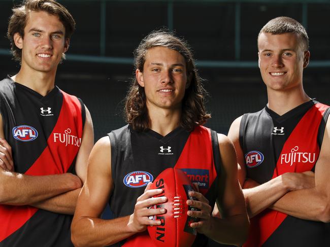 MELBOURNE, AUSTRALIA - DECEMBER 10: Zach Reid, draft selection #10 for the Bombers (L), Archie Perkins, draft selection #9 for the Bombers and Nik Cox, draft selection #8 for the Bombers (R) pose for a photo during the NAB AFL Draft media opportunity at Marvel Stadium on December 10, 2020 in Melbourne, Australia. (Photo by Dylan Burns/AFL Photos via Getty Images)