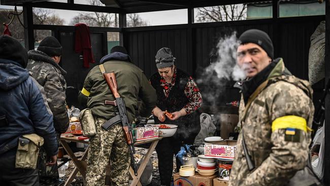 A woman cooks for Ukrainian soldiers at a frontline, northeast of Kyiv. Picture: AFP