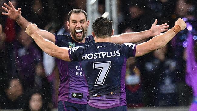 Cameron Smith (left) and Cooper Cronk of the Storm react after winning the NRL preliminary final between the Melbourne Storm and the Canberra Raiders at AAMI Park in Melbourne, Saturday, Sept. 24, 2016. (AAP Image/Julian Smith) NO ARCHIVING, EDITORIAL USE ONLY