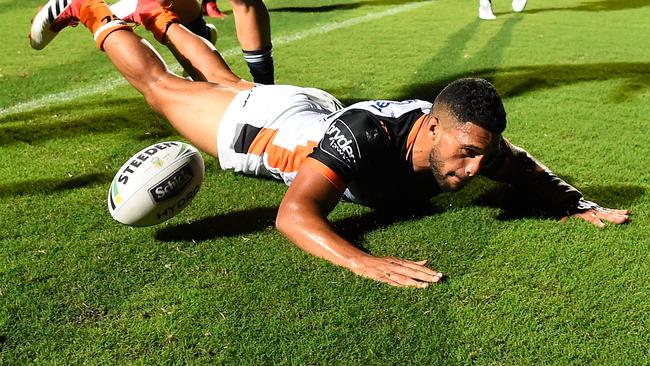 Taane Milne scores a try for Wests Tigers during their NRL trial match against the Cowboys.