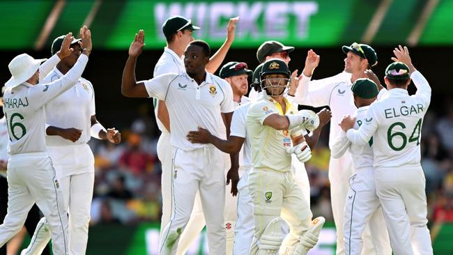 David Warner of Australia is seen walking from the field after losing his wicket to Kagiso Rabada of South Africa during day two of the First Test match between Australia and South Africa at The Gabba on December 18.