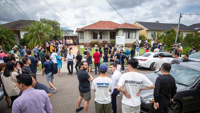 An auction in North Ryde, Sydney, draws a big crowd. The federal opposition claims the government is running a “Big Australia” policy by stealth. Picture: Julian Andrews