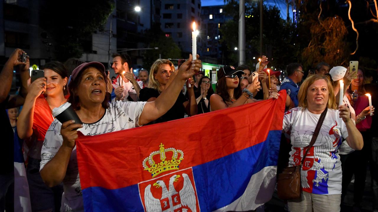 Djokovic’s supporters gathered in front of the hotel. Photo by William WEST / AFP