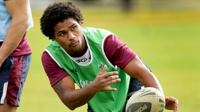 Jayden Hodges passes during Manly training.