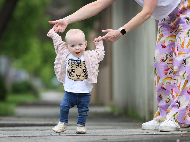 Molly walking with the aid of her mum Laura Papillo. Picture: David Caird