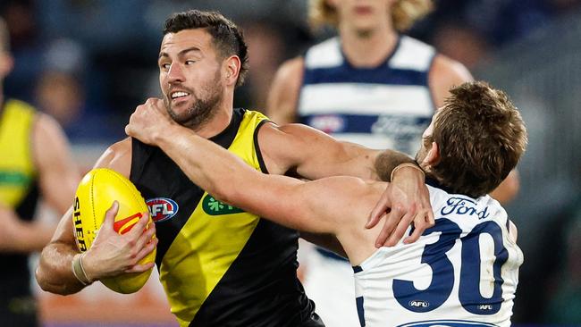 MELBOURNE, AUSTRALIA - JUNE 01: Jack Graham of the Tigers is tackled by Tom Atkins of the Cats during the 2024 AFL Round 12 match between the Geelong Cats and the Richmond Tigers at GMHBA Stadium on June 01, 2024 in Melbourne, Australia. (Photo by Dylan Burns/AFL Photos via Getty Images)