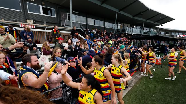 Crows players celebrate with fans after a win. Picture: Getty Images