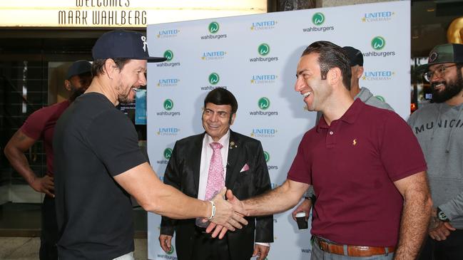 In December 2020, Hollywood star Mark Wahlberg shook hands with Sam Mustaca from United Cinemas as Sam’s father Roy Mustaca looked on. Picture: Chris Khoury