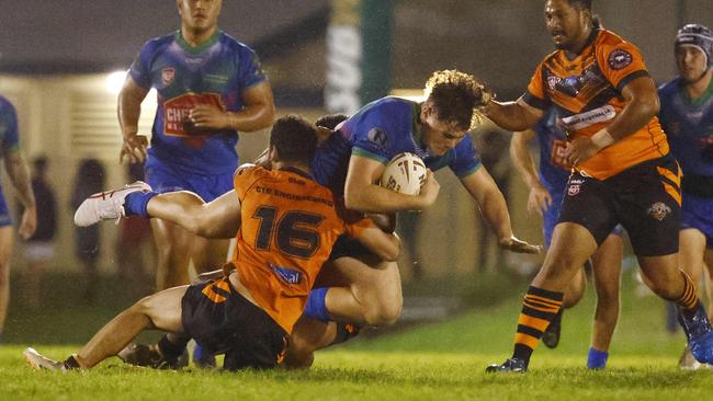 Innisfail's Jason Hallie crashes through a tackle in the FNQRL A-grade match against Tully Tigers at Callendar Park. Picture: Brendan Radke