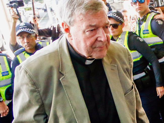 FILE - In this March 5, 2018, file photo, Cardinal George Pell arrives for a hearing at an Australian court in Melbourne, Australia. A lawyer for the most senior Vatican official ever charged in the Catholic Church sex abuse crisis told the Australian court on Tuesday, April 17, 2018 that Pell could have been targeted with false accusations to punish him for the crimes of other clerics. (AP Photo/Asanka Brendon Ratnayake, File)