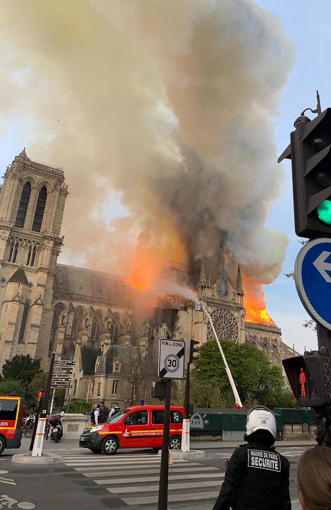 Flames and smoke are seen billowing from the roof at Notre-Dame Cathedral in Paris on April 15, 2019. (Photo by Patrick ANIDJAR / AFP)