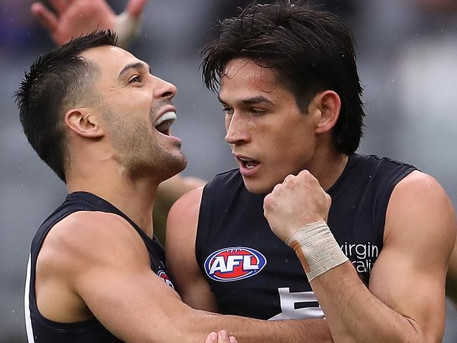 Michael Gibbons congratulates 22-year-old Zac Fisher for one of his four goals against the Eagles in his first senior game of 2020.