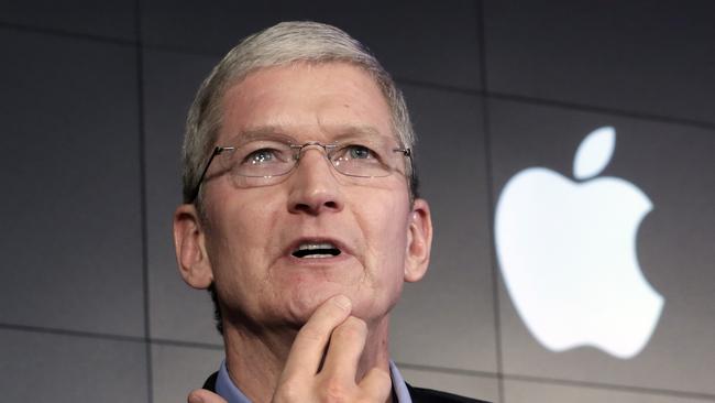 Apple CEO Tim Cook responds to a question during a news conference at IBM Watson headquarters, in New York.