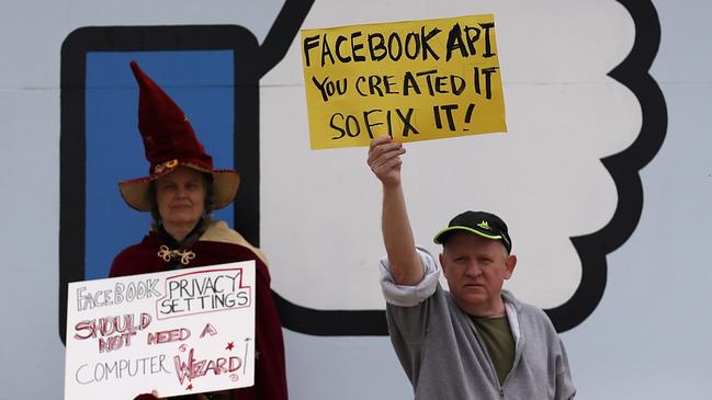 Protesters with the group "Raging Grannies" hold signs during a demonstration outside of Facebook headquarters in April. Picture: AFP