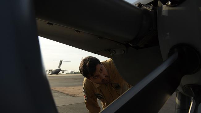 French Airforce does pre-flight check on helicopter before flying media to the HMAS Perth as part of Operation Kakadu. Picture: (A)manda Parkinson