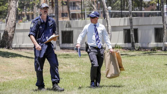 NSW Police carry bags, possibly evidence, found along the shore of the Tweed River during a case. (AAP Image/Tim Marsden) 