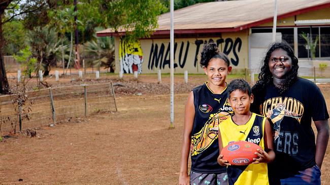 Caitlin McLennan, 15, John Rioli, 13, and Isabella Puruntatameri, 15, on the local dusty dirt oval in the small community of Pirlangimpi.