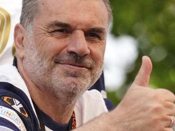 Tottenham Hotspur manager Ange Postecoglou on the open-top team bus during the Europa League winners parade in North London, Friday, May 23, 2025. (John Walton/PA via AP)