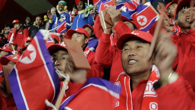 Supporters of the North Korea team cheer during the World Cup group G soccer match between Brazil and North Korea at Ellis Park Stadium in Johannesburg, South Africa, Tuesday, June 15, 2010. (AP Photo/Tom Curley)