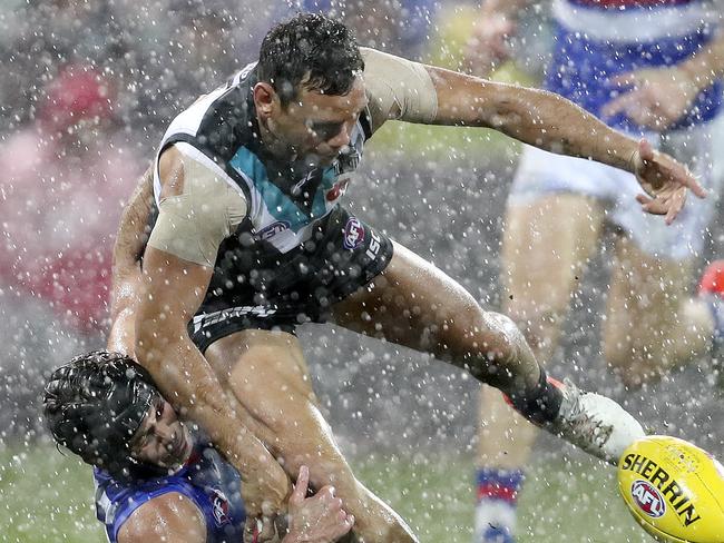 Bulldogs Caleb Daniel grapples with Steven Motlop in the wet. Picture: Sarah Reed