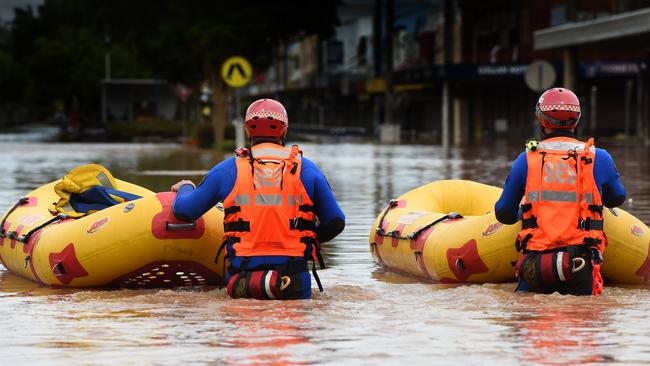 SES and police emergency crews move through the centre of Lismore looking for people in need of evacuation.