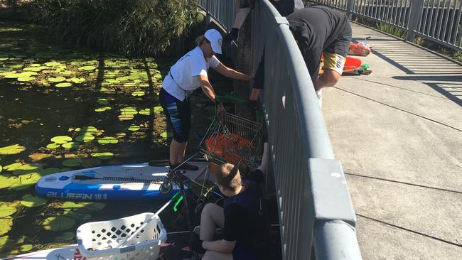 Year 8s from Arcadia College help to remove rubbish from three lakes around Robina. Picture: Two Llamas Environmental &amp; Social Projects