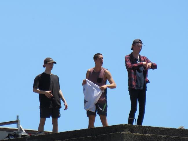 The youths pose on the silo’s summit.