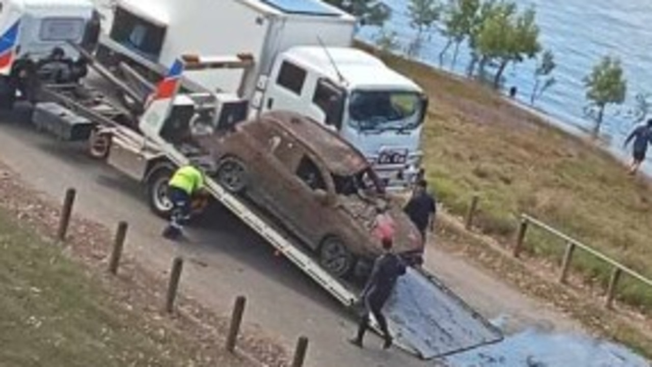 Police divers on scene as car pulled from the Burnett River