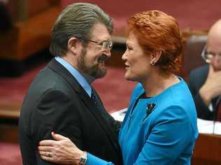 Justice Party Senator Derry Hinch congratulates One Nation leader Senator Pauline Hanson after making her maiden speech in the Senate in Canberra. Picture: MICK TSIKAS