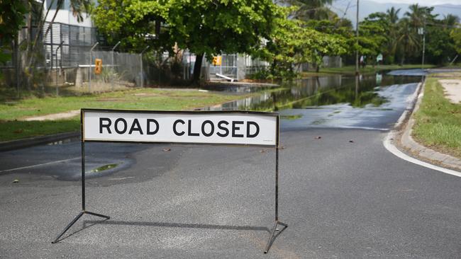 A section of Aumuller Street in the Cairns suburb of Portsmith closed to traffic due to partial flooding of the road from a king tide. Picture: Brendan Radke