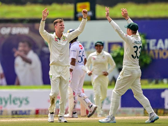 Matthew Kuhnemann and Marnus Labuschagne celebrate a wicket. Picture: AFP