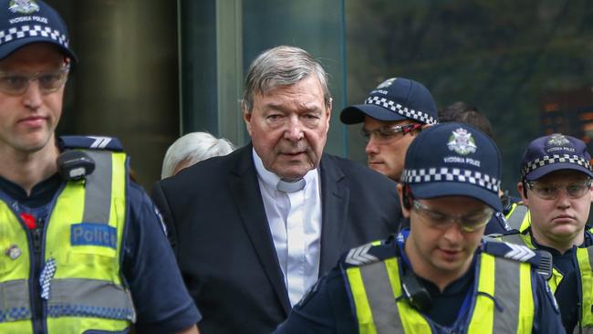 George Pell leaves court in Melbourne surrounded by police in May last year. Picture: AP