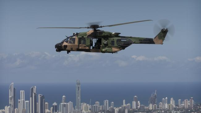 An Australian Army Multi Role Helicopteraircraft flies the Queensland Police Service Special Emergency Response Team over the Gold Coast as part of familiarisation training for the 2018 Commonwealth Games.