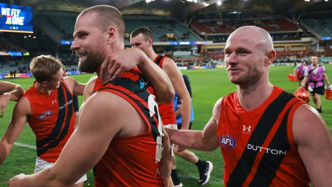 ADELAIDE, AUSTRALIA - APRIL 19: Jake Stringer and Nick Hind of the Bombers celebrate their win during the 2024 AFL Round 06 match between the Adelaide Crows and the Essendon Bombers at Adelaide Oval on April 19, 2024 in Adelaide, Australia. (Photo by James Elsby/AFL Photos via Getty Images)