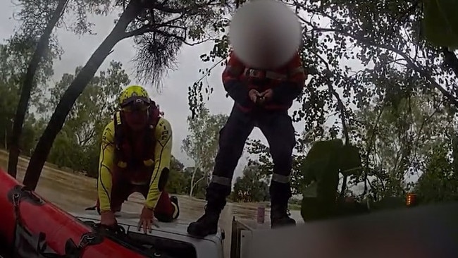 Swift water rescue crews rescued a driver stranded on his ute's roof after his vehicle was swept of the roadway at Balyendo crossing. Image: QFD